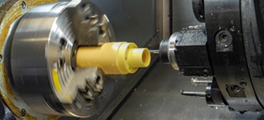 Bar stock consisting of iglidur® high-performance polymers is turned to achieve the correct shape.