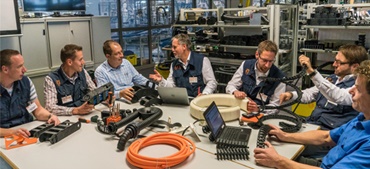 igus employees sit at the table with products